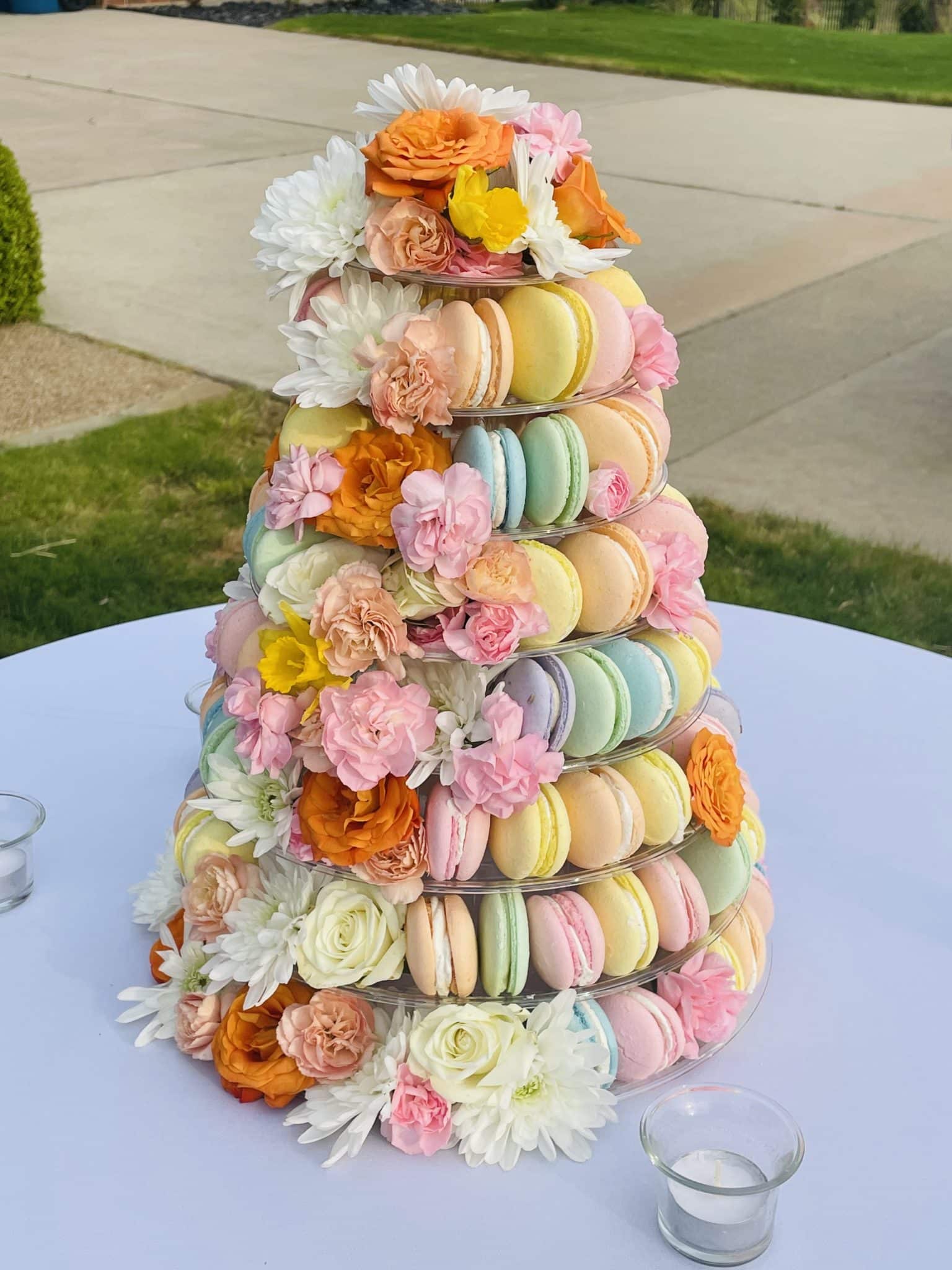 Colorful tower of macarons with fresh flowers | Petite Sweets by Laura