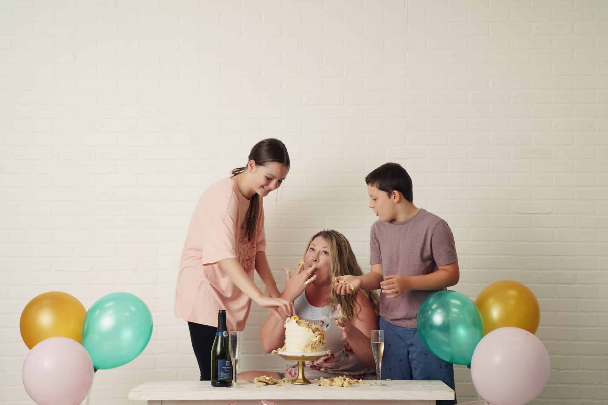 Laura with her kids doing a cake smash | Petite Sweets by Laura | Photo by Lala Photography