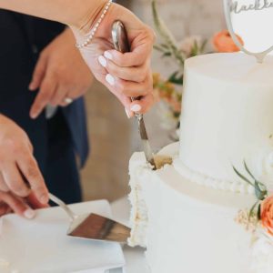 The first slice of wedding cake | Petite Sweets by Laura | Photo by Bowtie Media