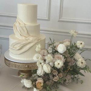 Classy white wedding cake with drapery and fresh floral | Petite Sweets by Laura