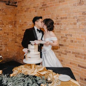 Couple kiss after a bite of cake | Petite Sweets by Laura | Photo by AnelM. Photography